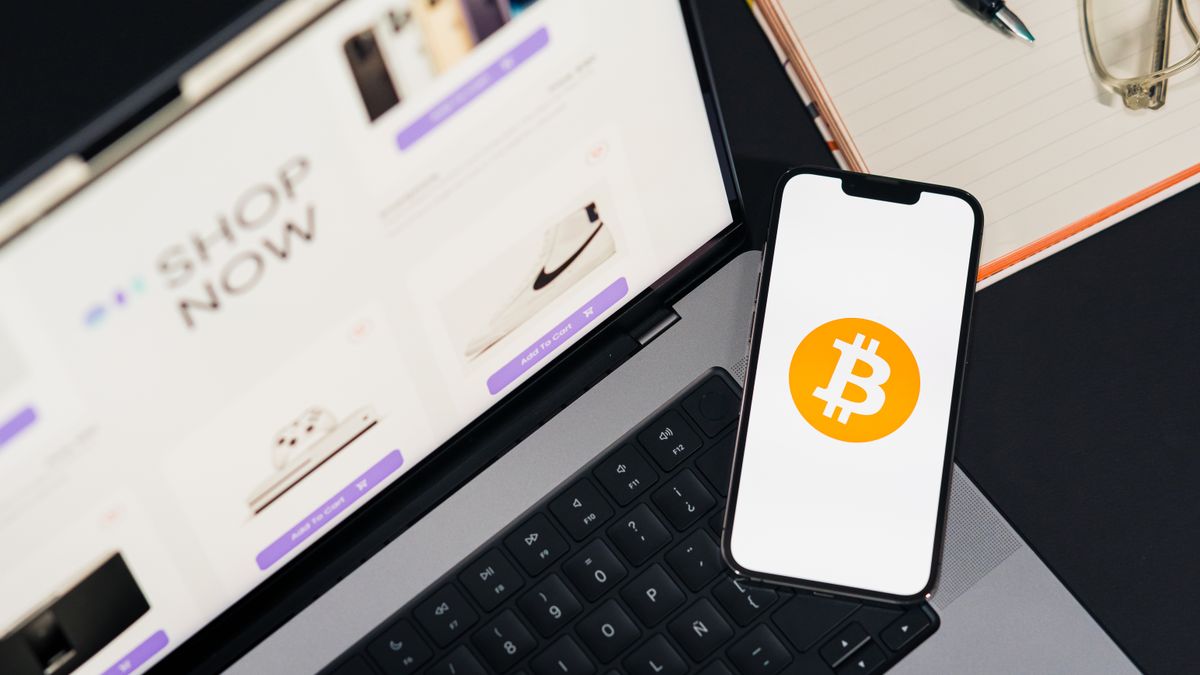 Laptop and smartphone with Bitcoin symbol, depicting digital shopping