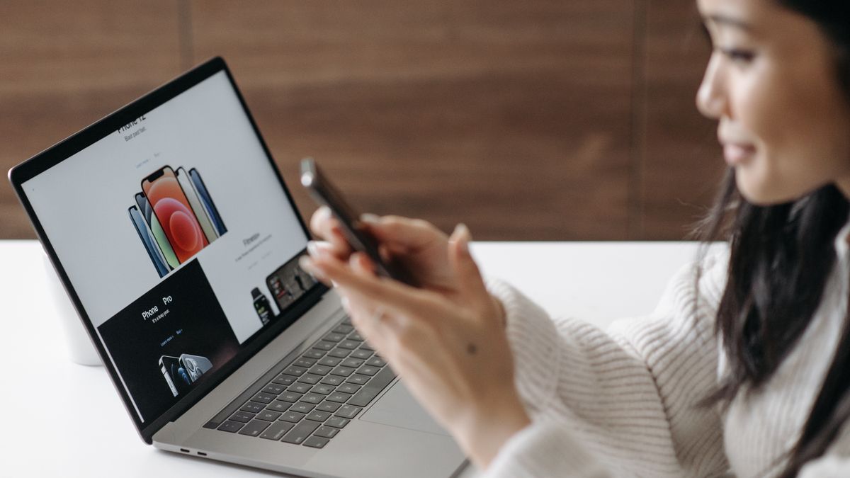 Asian woman shopping online with a laptop and smartphone at home