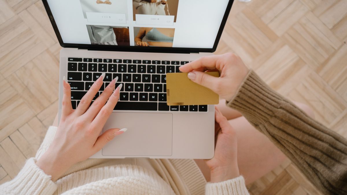 Person shopping online using a laptop and credit card, highlighting e-commerce convenience
